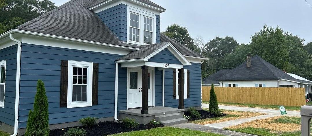 blue house with manicured yard