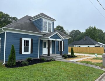 blue house with manicured yard
